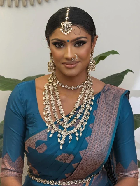 Blue silk saree with bright traditional jewellery and bridal makeup
