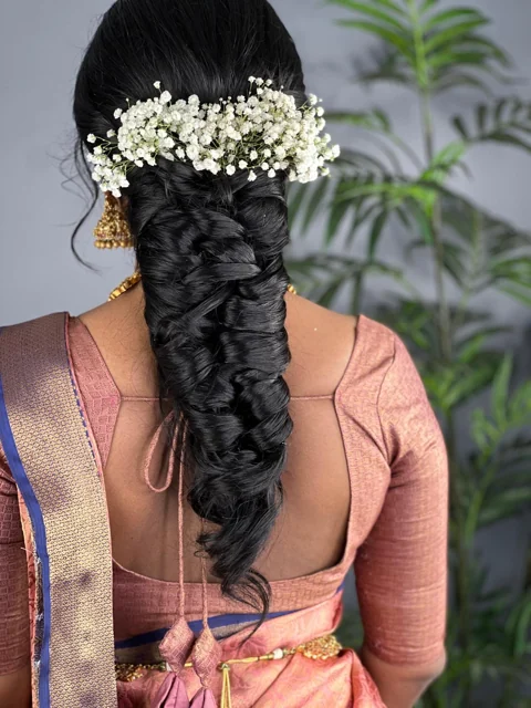 Detailed bridal braid finished with a full arrangement of white flowers