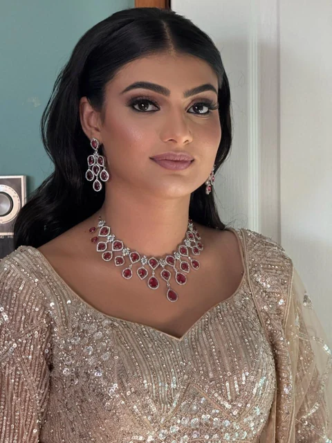 Soft glam reception makeup with long styled hair and a champagne outfit